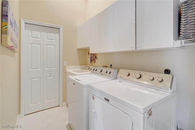 laundry room with washer and dryer, cabinets, light tile patterned floors, and sink