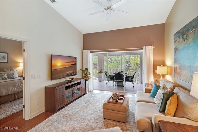 living room featuring ceiling fan, lofted ceiling, and hardwood / wood-style flooring