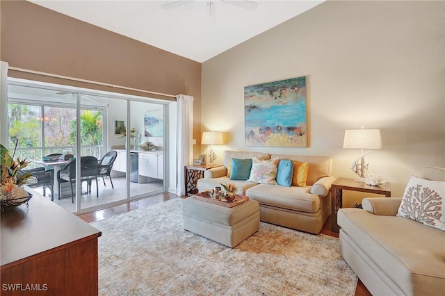 living room featuring vaulted ceiling, ceiling fan, and light hardwood / wood-style floors