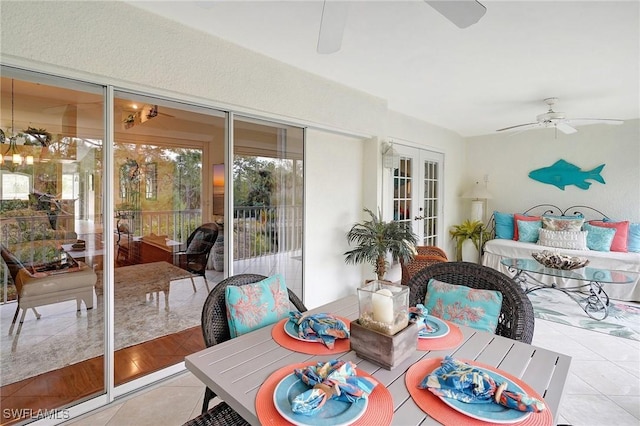 sunroom / solarium featuring ceiling fan and french doors