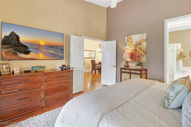 bedroom featuring ensuite bathroom and light hardwood / wood-style flooring