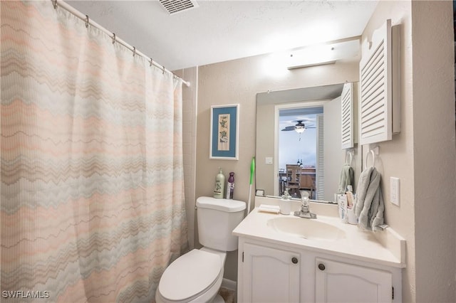 bathroom with a shower with curtain, vanity, and toilet