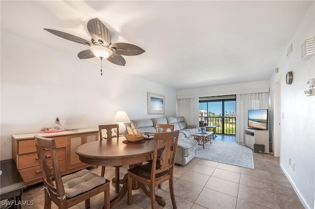 tiled dining room featuring ceiling fan