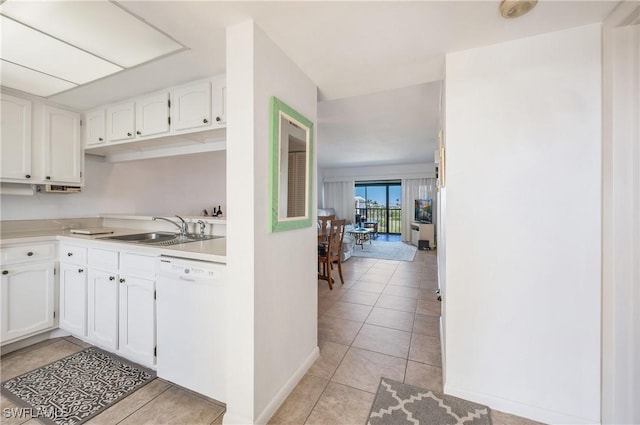 kitchen featuring white cabinetry, dishwasher, sink, and light tile patterned floors