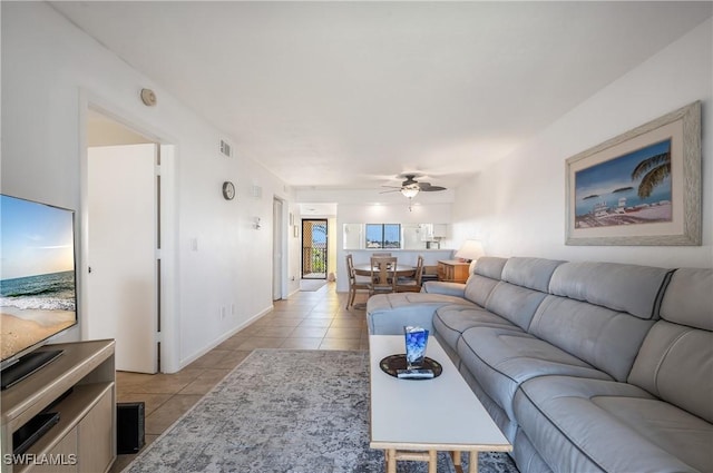 tiled living room with ceiling fan