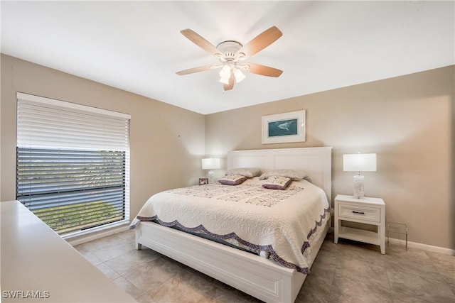 tiled bedroom featuring ceiling fan