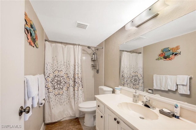 bathroom featuring vanity, walk in shower, and toilet