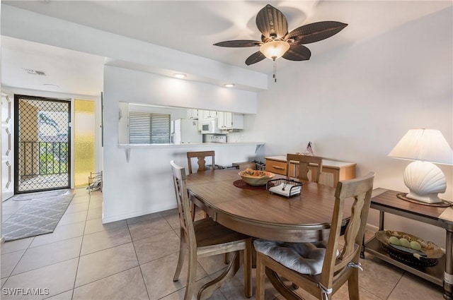 tiled dining area with ceiling fan