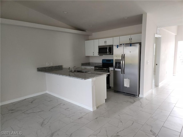 kitchen featuring kitchen peninsula, appliances with stainless steel finishes, sink, stone countertops, and white cabinetry