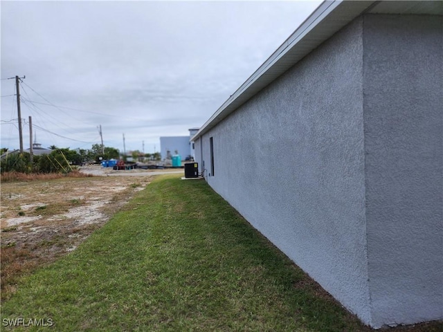 view of property exterior featuring a yard and cooling unit