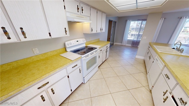 kitchen with white cabinets, white appliances, sink, and light tile patterned floors