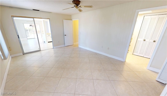 spare room with light tile patterned floors and ceiling fan