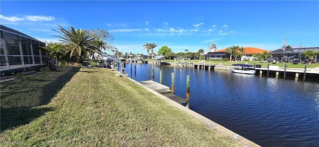 view of dock featuring a water view and a yard