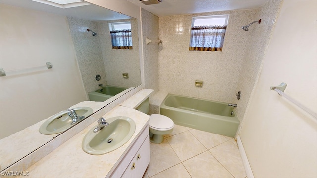 full bathroom featuring toilet, vanity, tile patterned floors, and tiled shower / bath