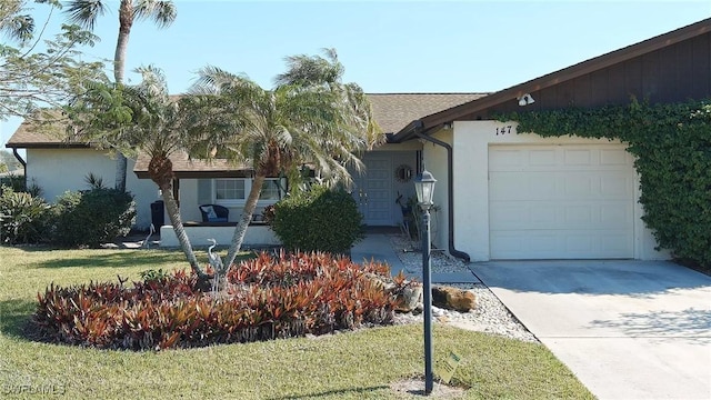 single story home with a front yard and a garage