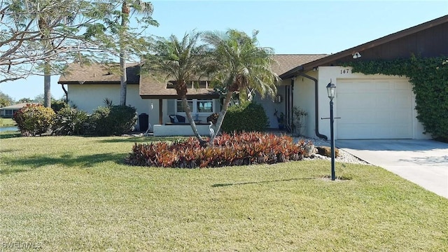 view of front of house with a front lawn and a garage