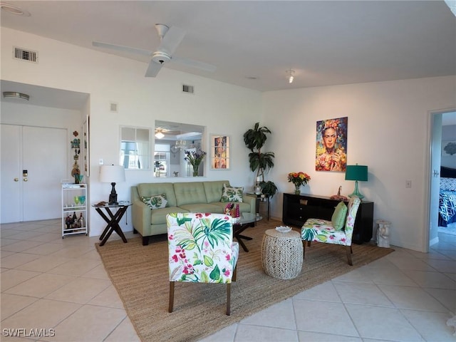 living room with light tile patterned floors and ceiling fan