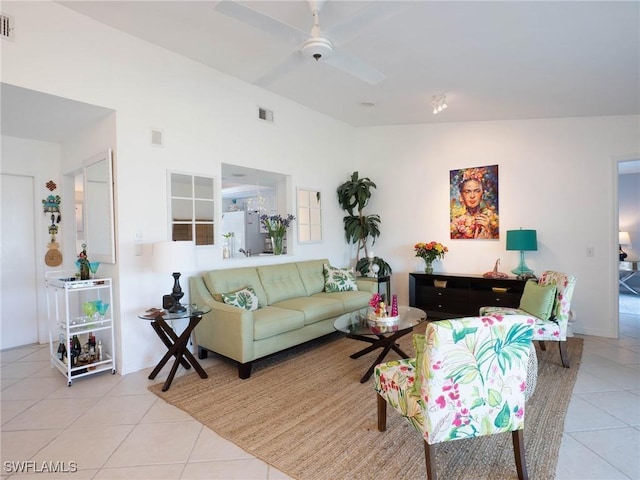 living room featuring vaulted ceiling, ceiling fan, and light tile patterned flooring