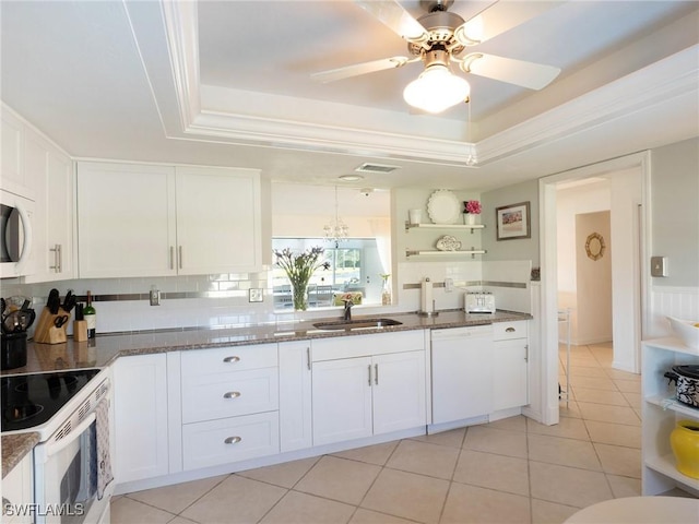 kitchen with dishwasher, white cabinets, a raised ceiling, and sink