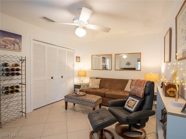 living room featuring ceiling fan and light tile patterned flooring