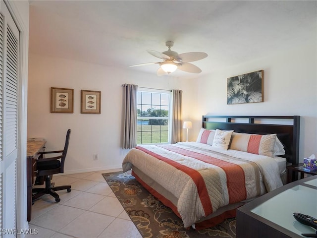 tiled bedroom with a closet and ceiling fan