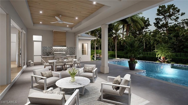 view of swimming pool with a patio area, outdoor lounge area, exterior kitchen, area for grilling, and ceiling fan