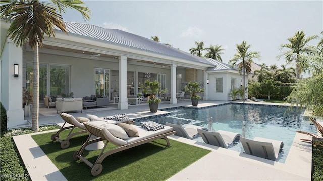 view of swimming pool with a patio, ceiling fan, pool water feature, and an outdoor living space