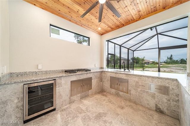 view of patio with a lanai, wine cooler, ceiling fan, and sink