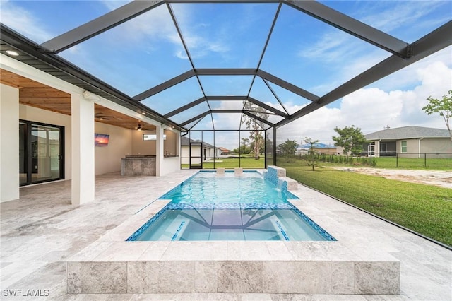 view of pool with ceiling fan, a yard, pool water feature, a patio area, and an in ground hot tub