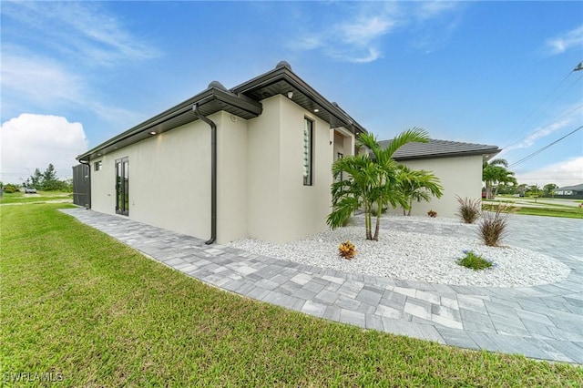 view of home's exterior with a lawn