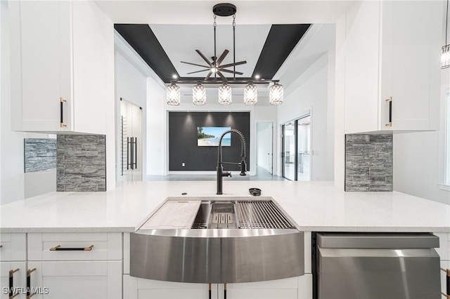 kitchen with pendant lighting, white cabinets, sink, ceiling fan, and tasteful backsplash