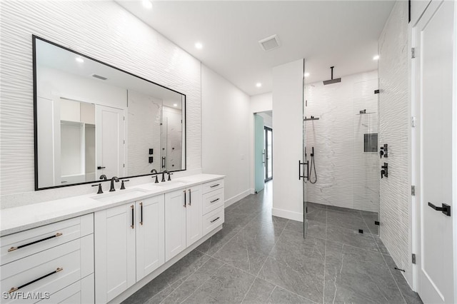 bathroom with vanity and a shower with shower door