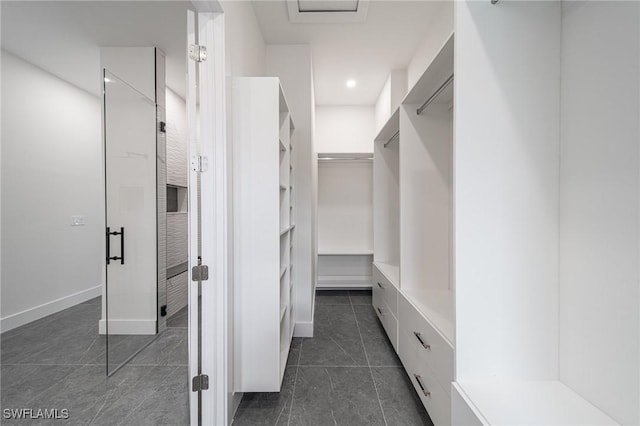 walk in closet featuring dark tile patterned flooring