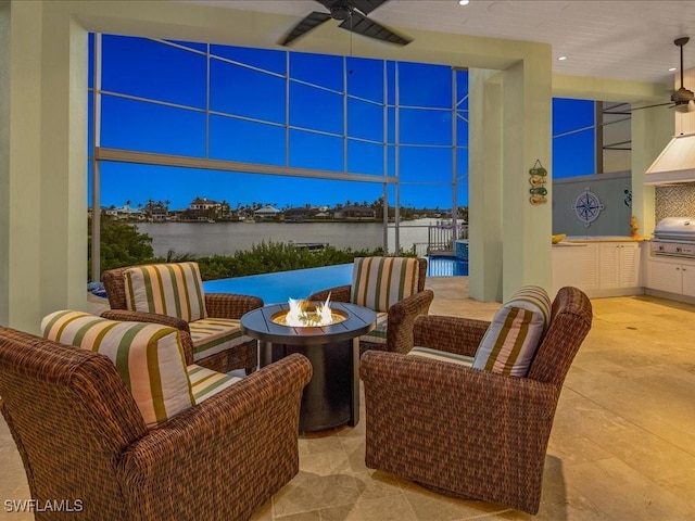 view of patio / terrace featuring area for grilling, a fire pit, and a water view