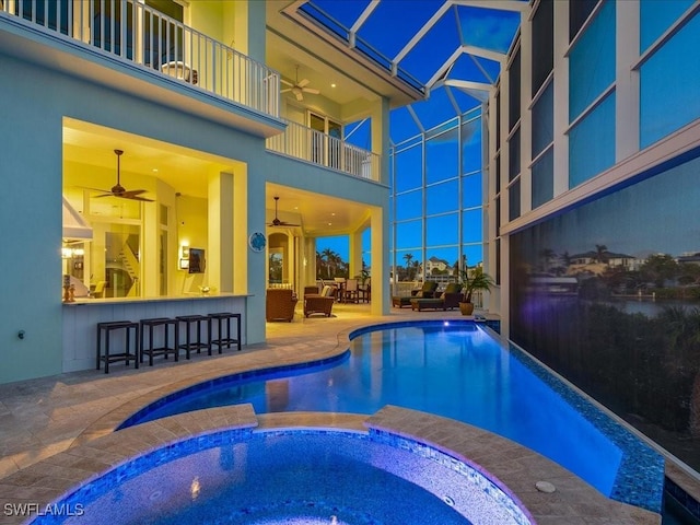 view of swimming pool featuring an in ground hot tub, ceiling fan, an outdoor bar, and a patio area