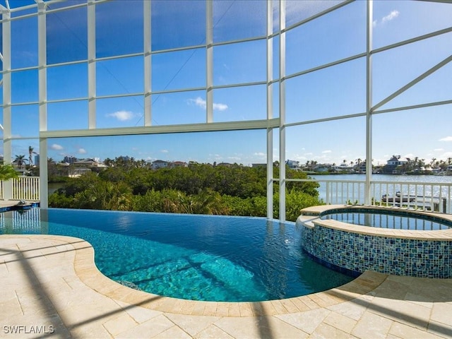 view of pool featuring an in ground hot tub, a water view, and a patio