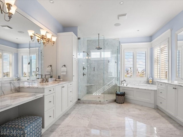 bathroom featuring vanity, separate shower and tub, and an inviting chandelier