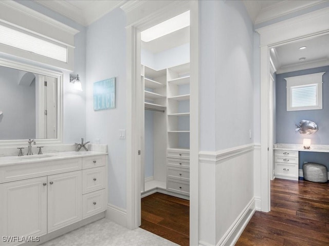 bathroom with vanity, wood-type flooring, and ornamental molding