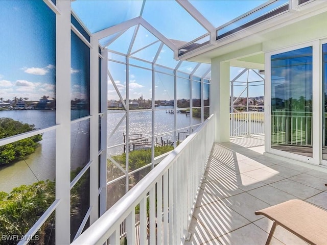 unfurnished sunroom with a water view