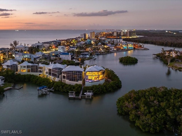 aerial view at dusk with a water view