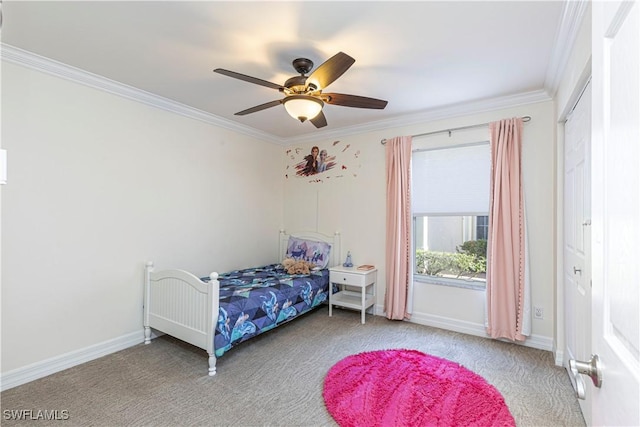 carpeted bedroom with ceiling fan, crown molding, and a closet