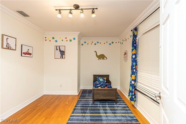 game room with crown molding and hardwood / wood-style flooring