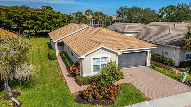 view of front of home with a front lawn and a garage