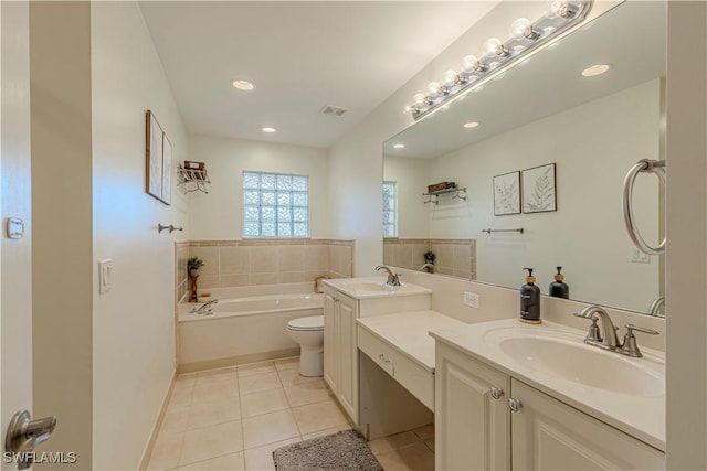 bathroom with toilet, a bath, vanity, and tile patterned flooring