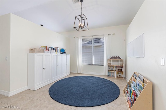 miscellaneous room with an inviting chandelier and light tile patterned floors