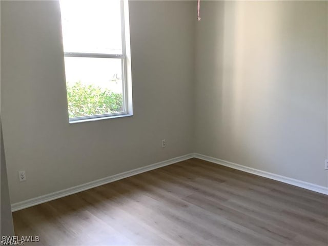 unfurnished room with hardwood / wood-style flooring