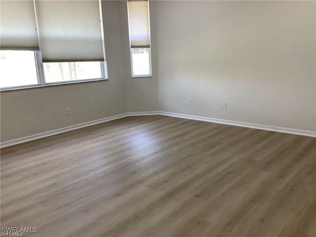 empty room featuring hardwood / wood-style floors and a healthy amount of sunlight