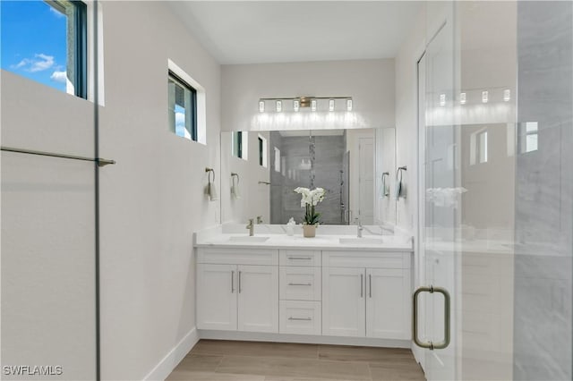 bathroom featuring vanity and an enclosed shower