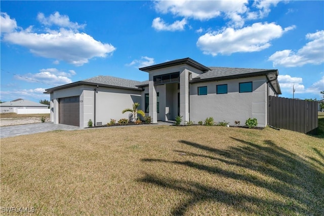 prairie-style house with a garage and a front lawn