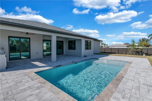 view of swimming pool with pool water feature, ceiling fan, and a patio area